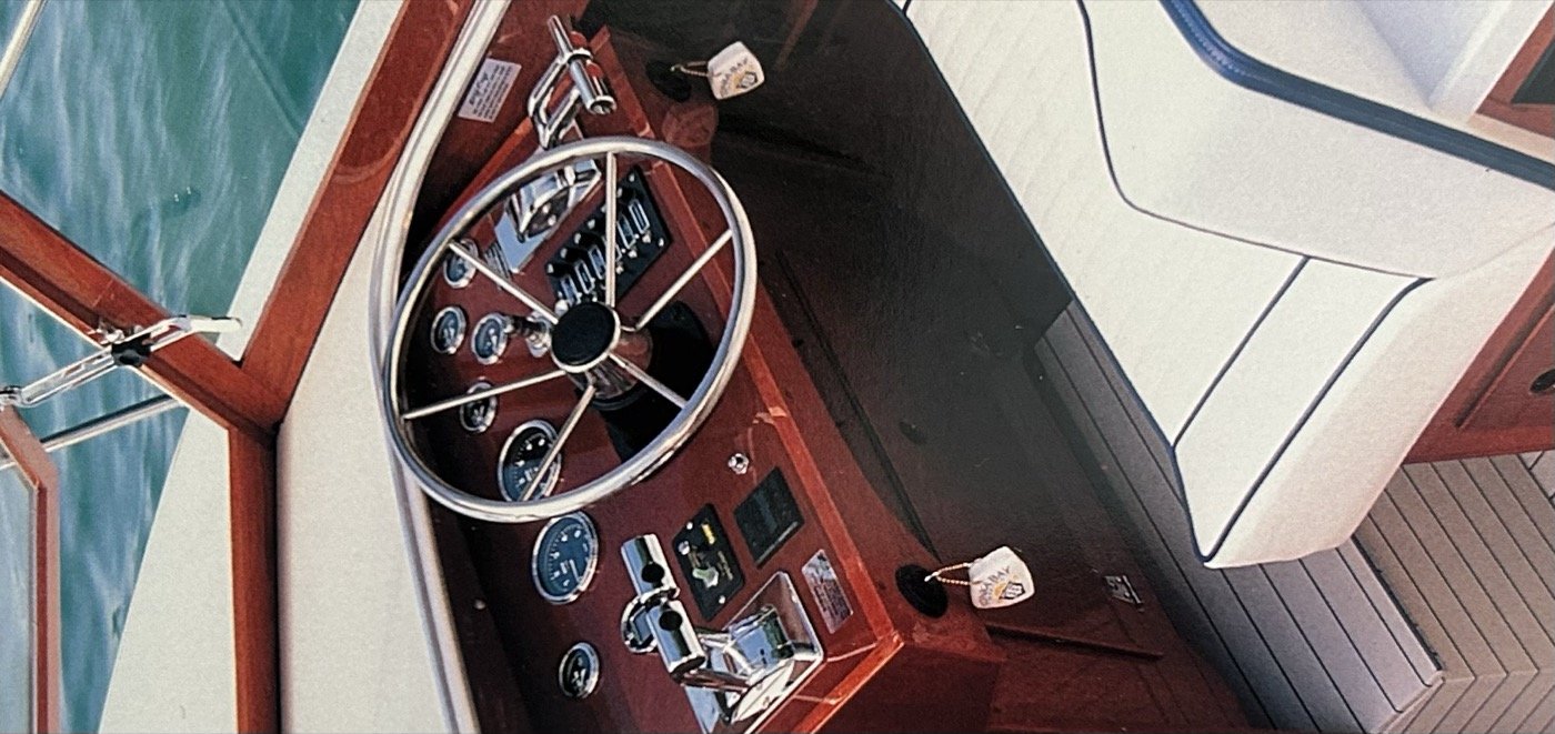 Skiff Craft helm — steering wheel, gauges and mahogany dash.