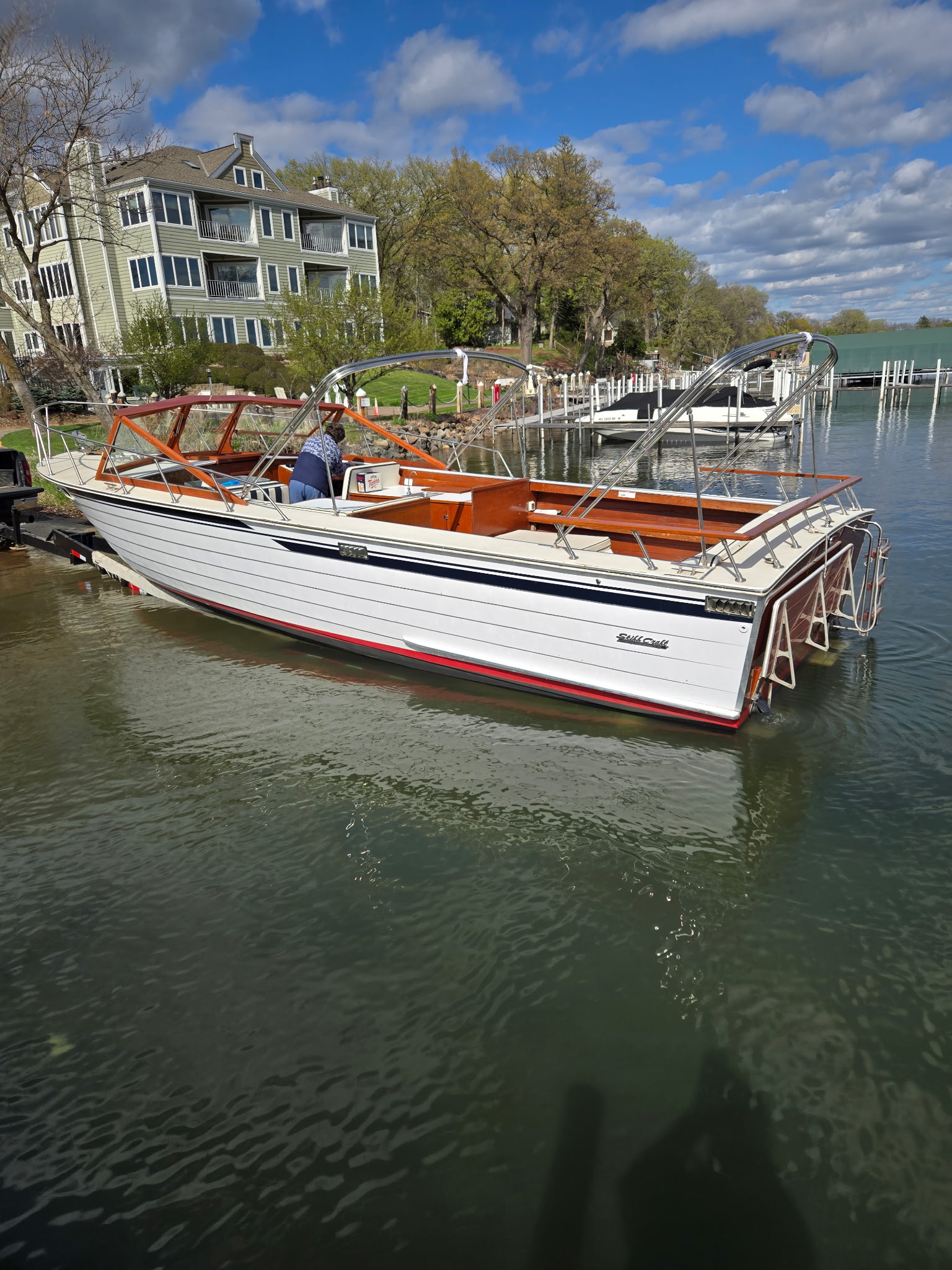 Skiff Craft Hardtop — at dock on a Minnesota lake, hardtop frame and covered helm clearly visible.